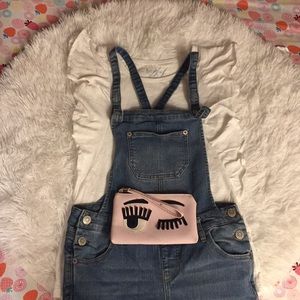 One pair of overalls a shirt and a wallet